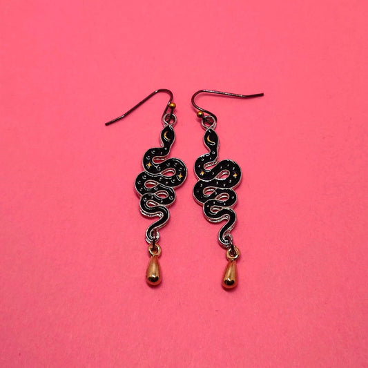 Gold and black moon child snake earrings.
